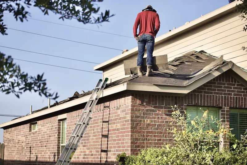 Professional roofer working on a residential roof in North New Hyde Park